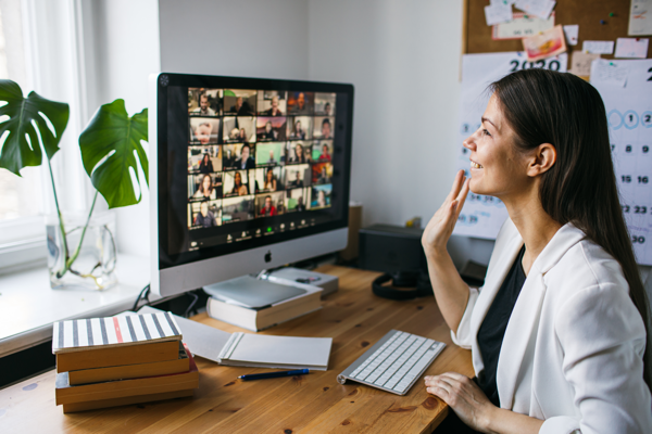 Woman waving in webinar